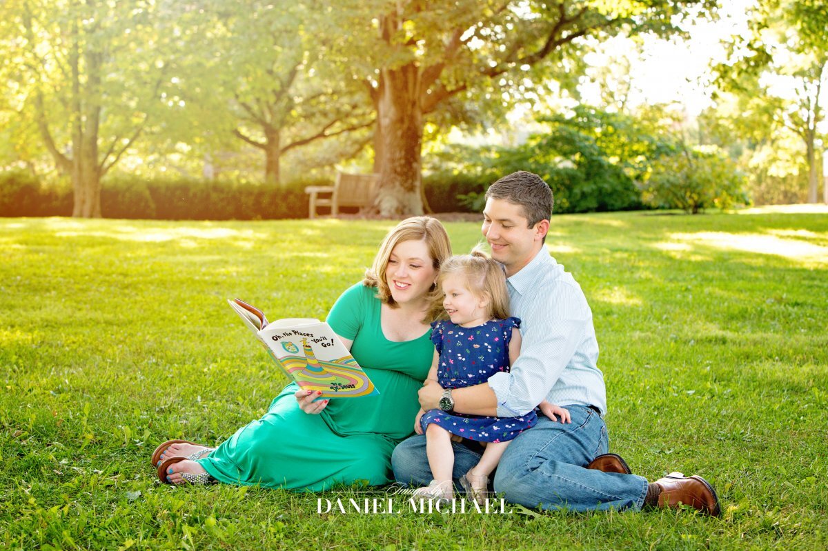 Parents reading book to child